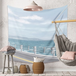 Coastal landscape tapestry featuring sea view and blue sky hanging in a cozy living room decor