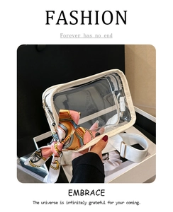 Detail of transparent PVC jelly bag featuring a white trim and chic printed silk scarf bow