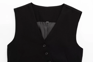 Close-up of black V-neck vest showing button closure and premium fabric texture