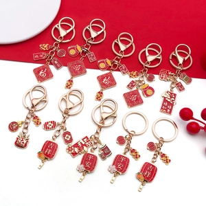 Detailed array of DIY Chinese New Year alloy pendants with red enamel charms and festive symbols