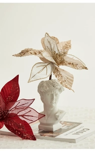 Artistic detail of 30cm glitter poinsettia flowers with David sculpture and CASA magazine