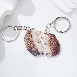 Detailed view of hedgehog acrylic keychains with silver metal rings and watercolor art