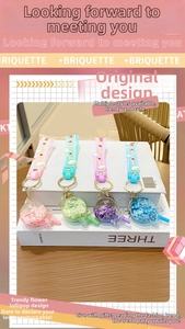 Close-up of colorful flower lollipop keychains with matching soft PVC wrist straps