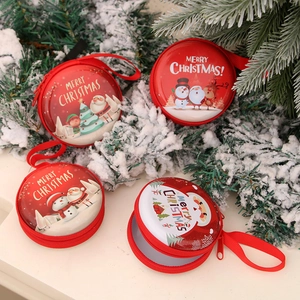 Set of round Christmas tin coin purses with Santa and reindeer motifs in festive snow scene