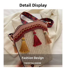 Detail of woven straw bucket bag featuring pink leather trim and colorful tassel charms