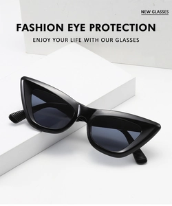Detail of black cat eye sunglasses on white geometric blocks with UV protection