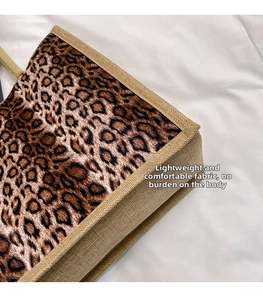 Detailed view of leopard print linen bag with natural fiber woven edges and handle