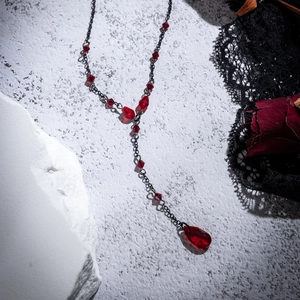 Detailed Gothic Y-necklace featuring black chains and blood-red crystal water drop pendant