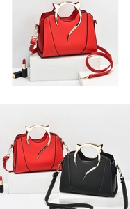 Detail view of stylish PU leather handbag featuring unique cat-ear shaped metal handles