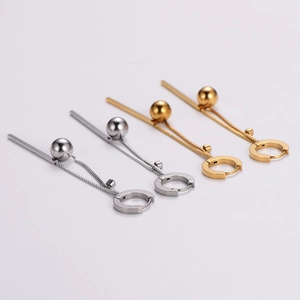 Long ball tassel earrings in gold and silver stainless steel finish on white background