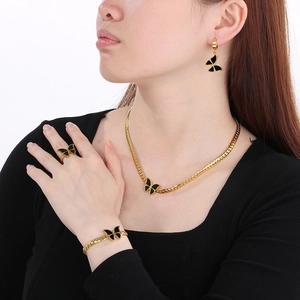 Close-up of a black acrylic butterfly jewelry set including necklace and earrings
