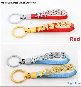 Detail of red and light blue leather keychains with gold metal rings and rhinestone letters