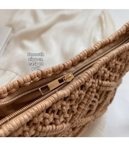 Detail of premium gold metal zipper and handmade cotton cord woven texture on a camel bag