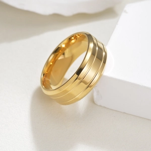 8mm golden stainless steel wedding ring with double grooves on a minimalist stand
