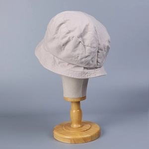 Detailed close-up of beige washed cotton sun hat with premium stitching and texture