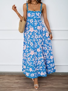 Close-up of bohemian blue floral dress featuring scalloped edges and a vibrant flower pattern