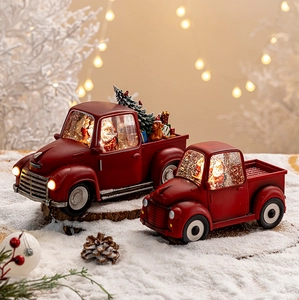 Close-up of a vintage red Christmas truck ornament with LED lights and festive details