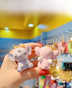 Detailed close-up of cute cartoon elephant keychains with crown and pearl details