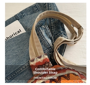Detail of bohemian geometric woven backpack with wide nylon straps on denim background