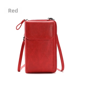 Detail view of red lychee textured phone crossbody bag with slim strap and front pocket
