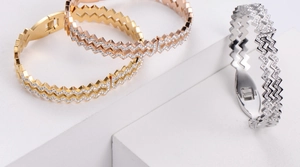 Detailed view of wave textured bracelets in gold, rose gold and silver with zircon