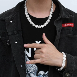 Macro detail of men's silver hip hop iced out necklace and bracelet set with cubic zirconia