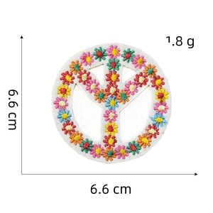 Detail of a 6.6 cm round embroidery patch with peace sign and colorful floral patterns