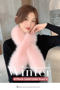 Detail view of pink faux fox fur cross scarf showing soft plush texture and fiber quality