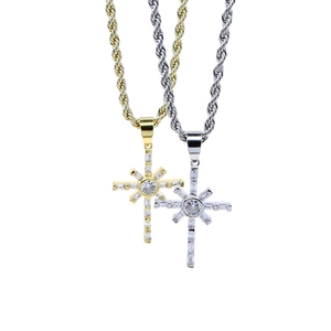 Detailed view of gold and silver hip hop cross pendants with cubic zirconia on rope chains