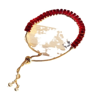 Elegant gold adjustable bracelet with vibrant red rectangular cubic zirconia crystals