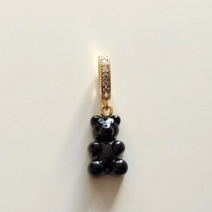 Close-up of black gummy bear charm with gold-plated bail set with sparkling zircons