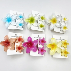 Set of resin plumeria flower hair claws in six vibrant colors on white card display