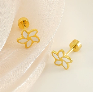 Detailed view of gold flower earrings with white enamel and secure screw back closure
