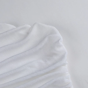 Close-up detail of white pleated textured fabric, soft stretch material for women tops.