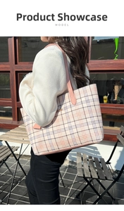 Side view of a checkered pink tote bag carried by a model in an outdoor setting