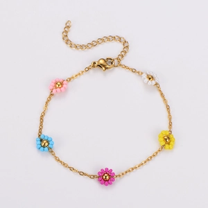 Detail of gold chain bracelet featuring colorful beaded daisy flowers and lobster clasp