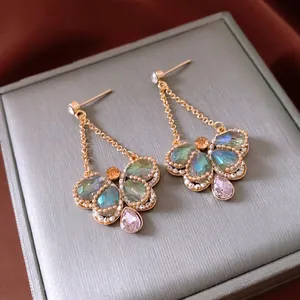 Vintage gold drop earrings with turquoise butterfly wings and pink teardrop gems