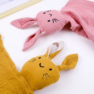 Detail of pink and yellow cotton gauze baby comforter towels with rabbit design