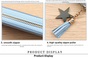 Detail of light blue coin purse featuring gold zipper, fringe tassel, and star pendant