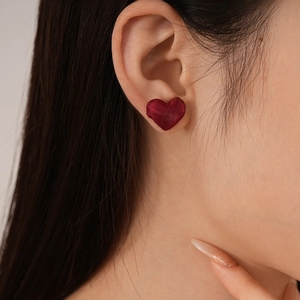 Close-up of deep red velvet heart stud earring worn on model for a vintage look