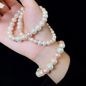 Close-up of elegant double-layered pearl bracelets in white pink and champagne colors