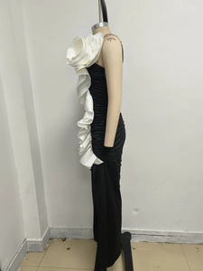Detailed view of large white floral applique on a black bodycon mermaid evening gown