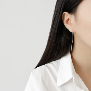Minimalist S925 sterling silver S-curve threader earring on model with polished finish