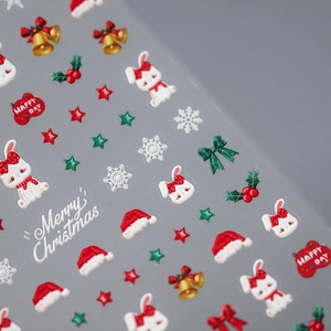 Matte Christmas nail art stickers with 3D red bows, bells and snowflakes on grey backdrop