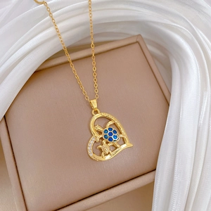 Detail of heart pendant necklace with blue turtles and I love you forever engraving
