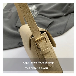 Detailed close-up of adjustable shoulder strap with golden metal buckle on beige bag