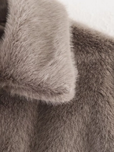 Close-up of mocha faux fur texture on the collar and shoulder of the fuzzy jacket