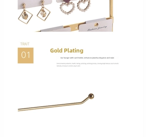 Detail of gold electroplated jewelry stand with earring cards and pearl heart drops