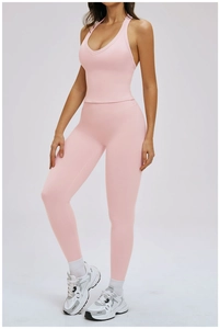 Detail view of pink high-waist yoga pants and racerback top set for fitness wear