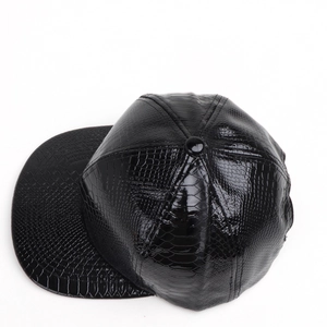 Detailed view of the black faux crocodile skin texture on a flat brim hip hop cap